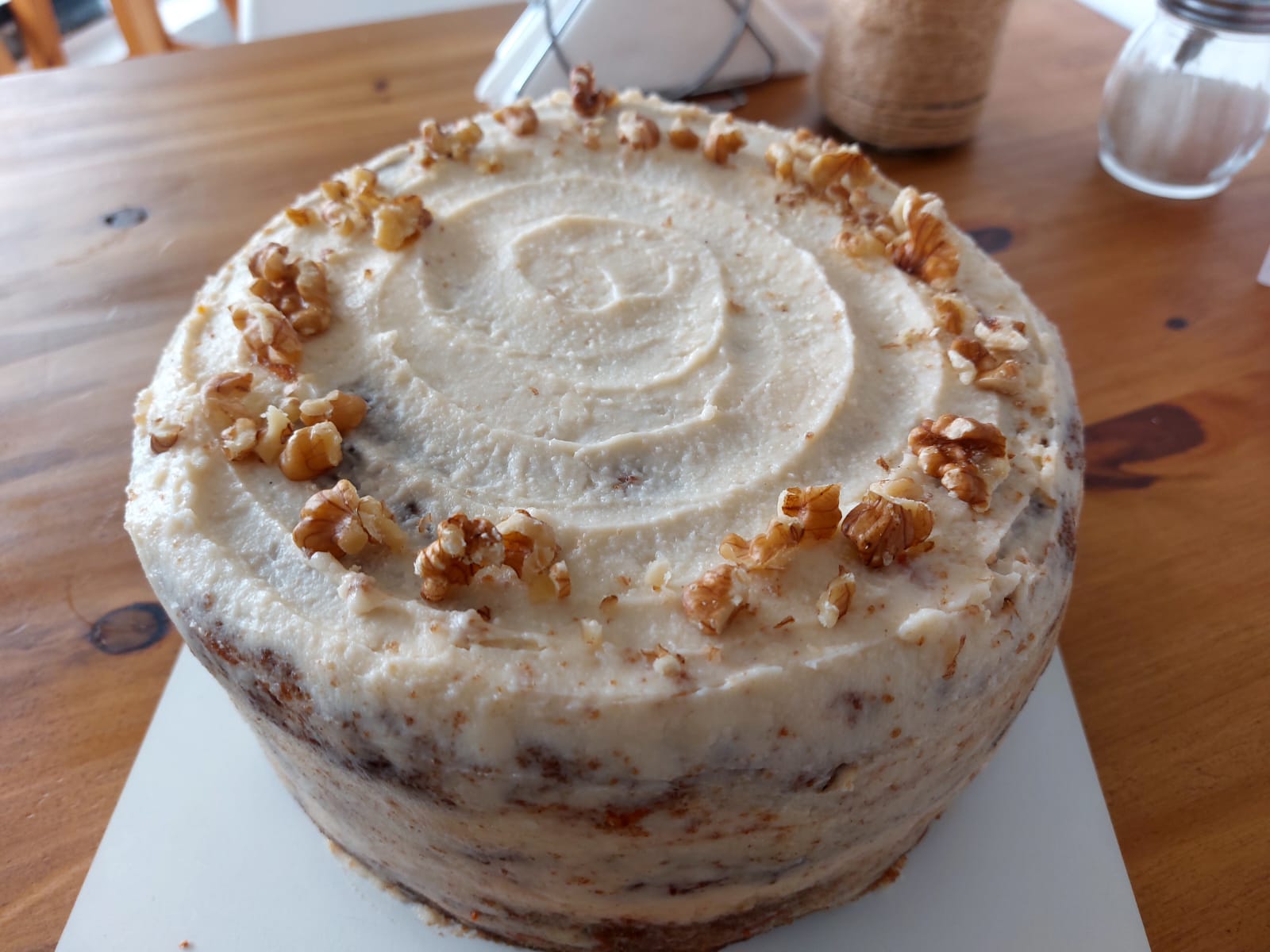 Carrot cake with cream on a wooden table