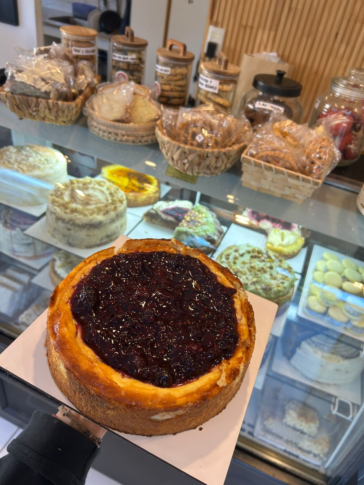 Red berry cheesecake in front of the pastry case