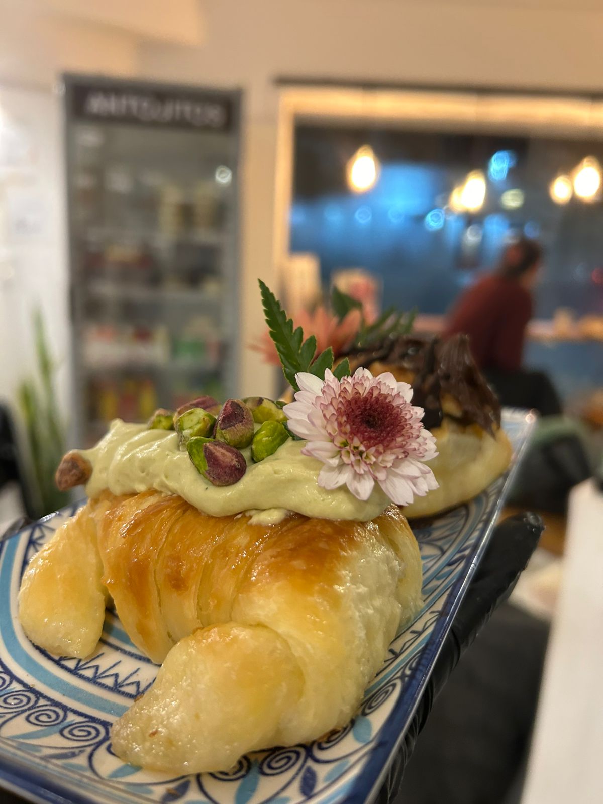 Croissant filled with pistachio cream and edible flowers